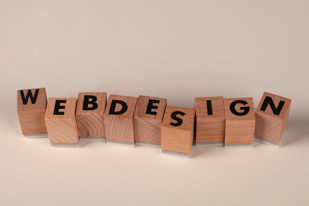 The Art of Drawing Readers In: Your attractive post title goes here Wooden blocks spelling 'web design' creatively showcase digital design concept.